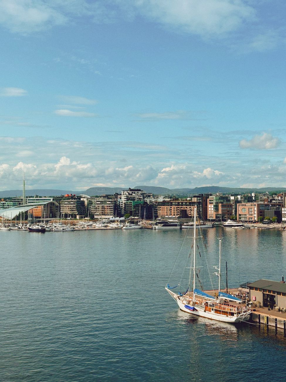 ship with masts moored in harbor